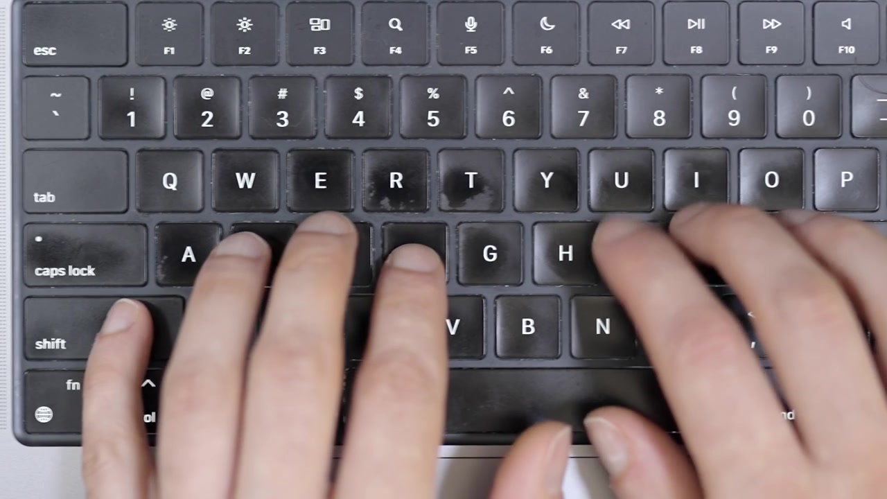 Close-up of hands typing on a computer keyboard, end of work
