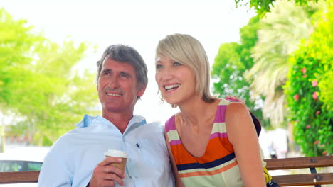 Smiling-couple-sitting-on-a-bench