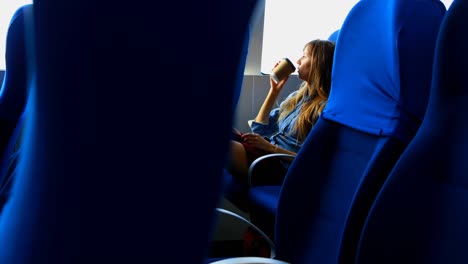 Woman-having-coffee-while-travelling-in-ferry-4k-