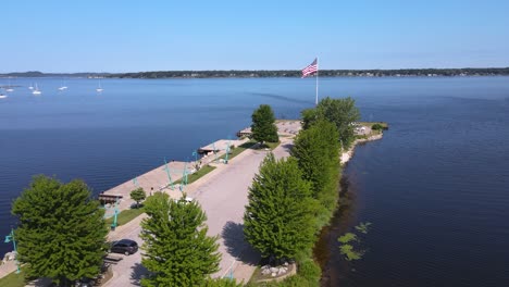 Push-forward-to-American-Flag-blowing-in-the-wind-at-Heritage-Landing-on-Muskegon-Lake