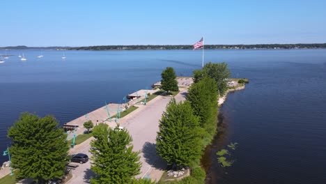 push forward to american flag blowing in the wind at heritage landing on muskegon lake