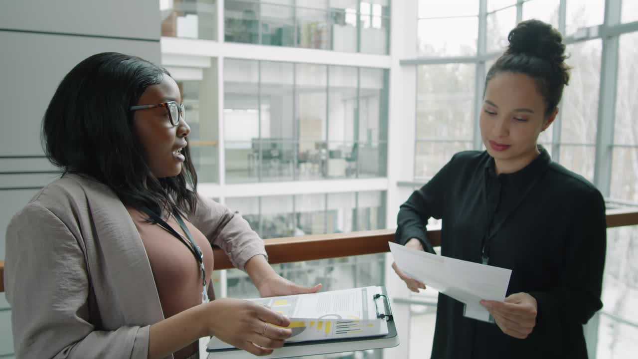 Multiethnic Business Ladies Discussing Documents