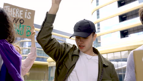 Young-Men-And-Woman-Vindicating-On-A-Protest-With-Boards-And-Megaphone