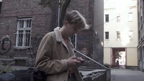 young man writing sms on mobile phone