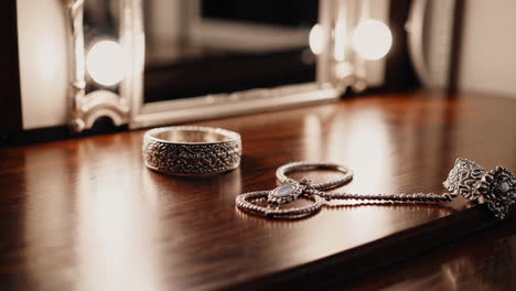 elegant silver jewelry on wooden table