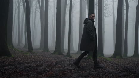 man walking in a foggy forest