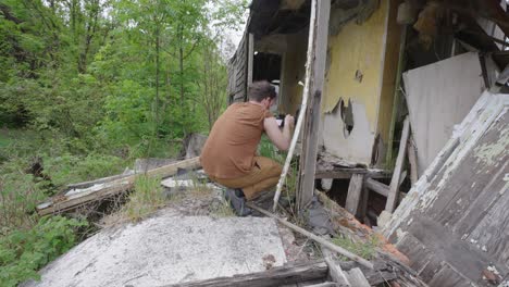 Male-photographer-on-assignment-at-ruins-of-a-building-captures-photos