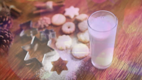 animación de puntos de luz sobre leche y galletas en navidad