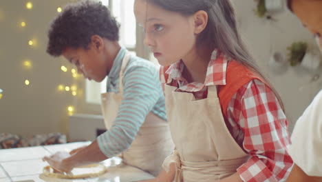 little girl preparing dough for baking on cooking masterclass