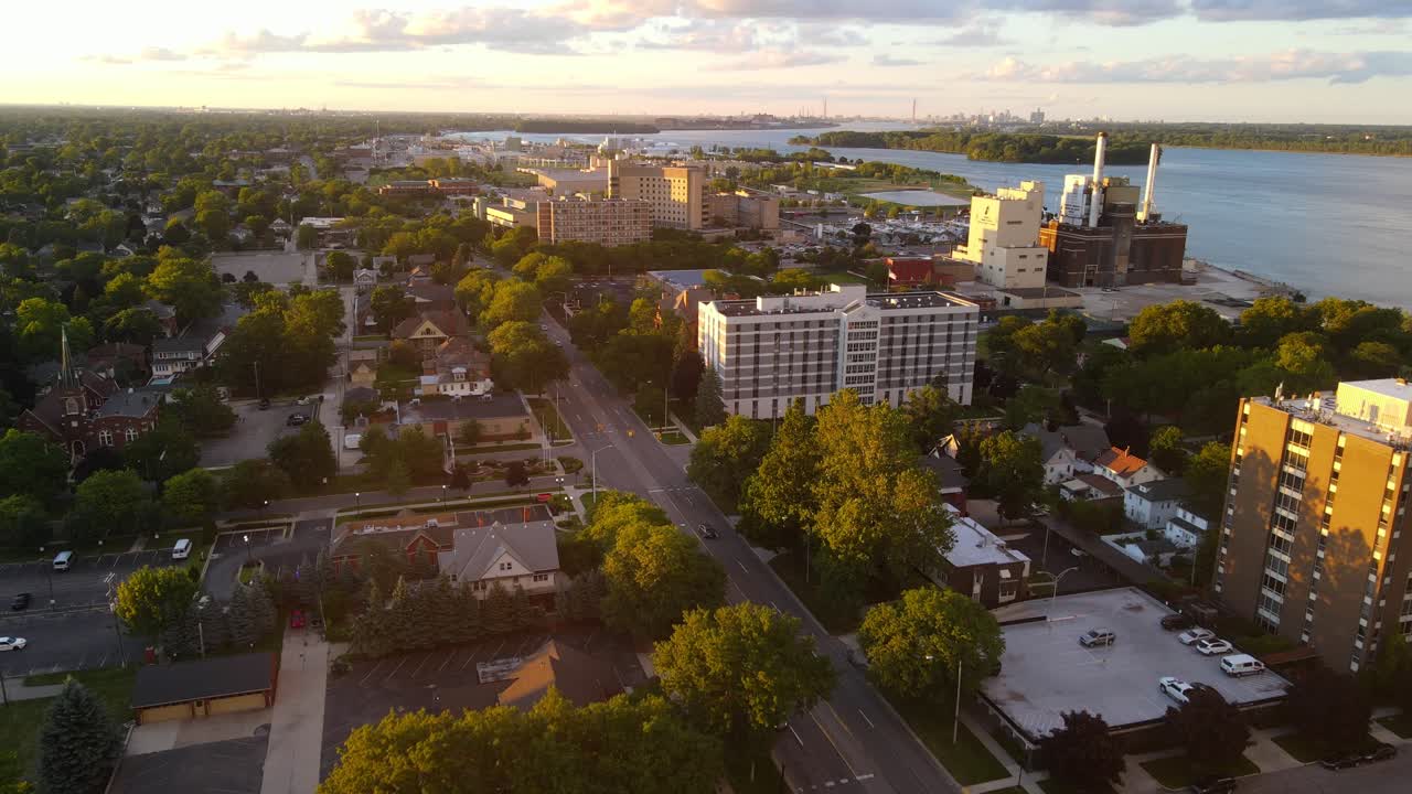 Downtown Wyandotte Michigan flying over Biddle Ave on warm summer evening with golden sunlight