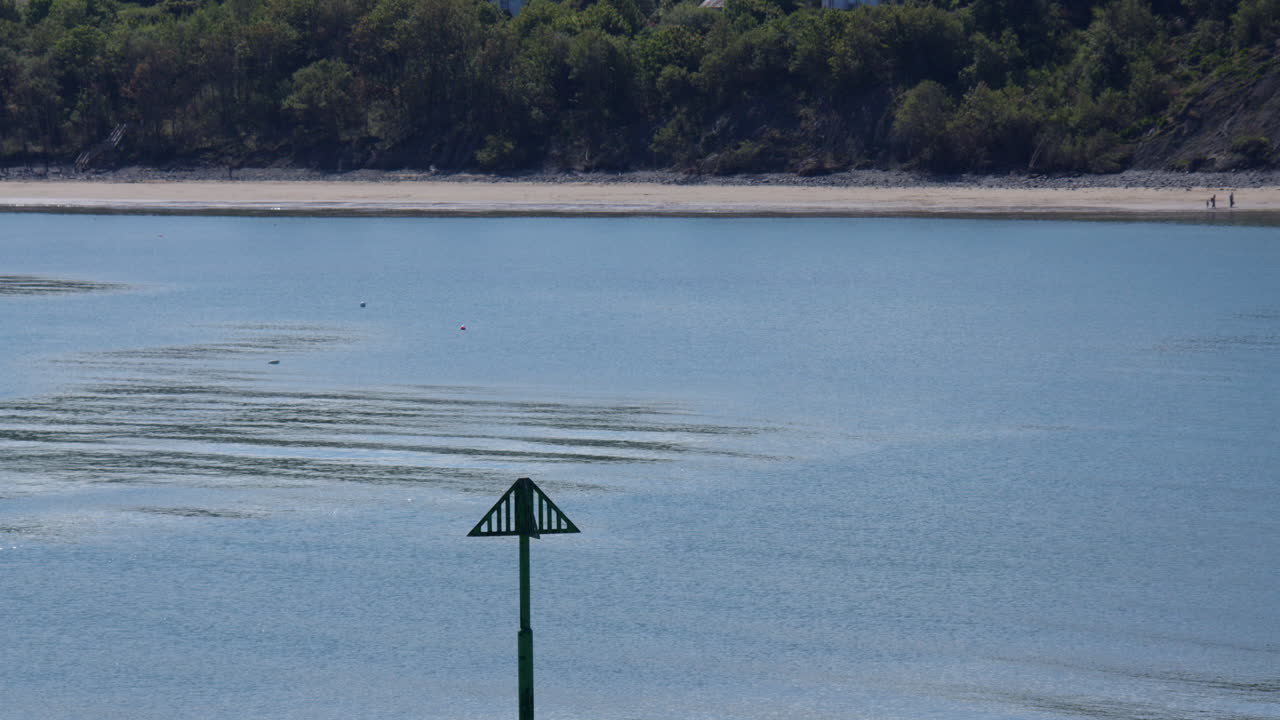 Long shot of new quay beach with groyne marker pole in Foreground