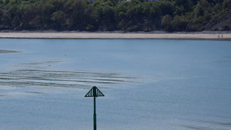 long shot of new quay beach with groyne marker pole in foreground