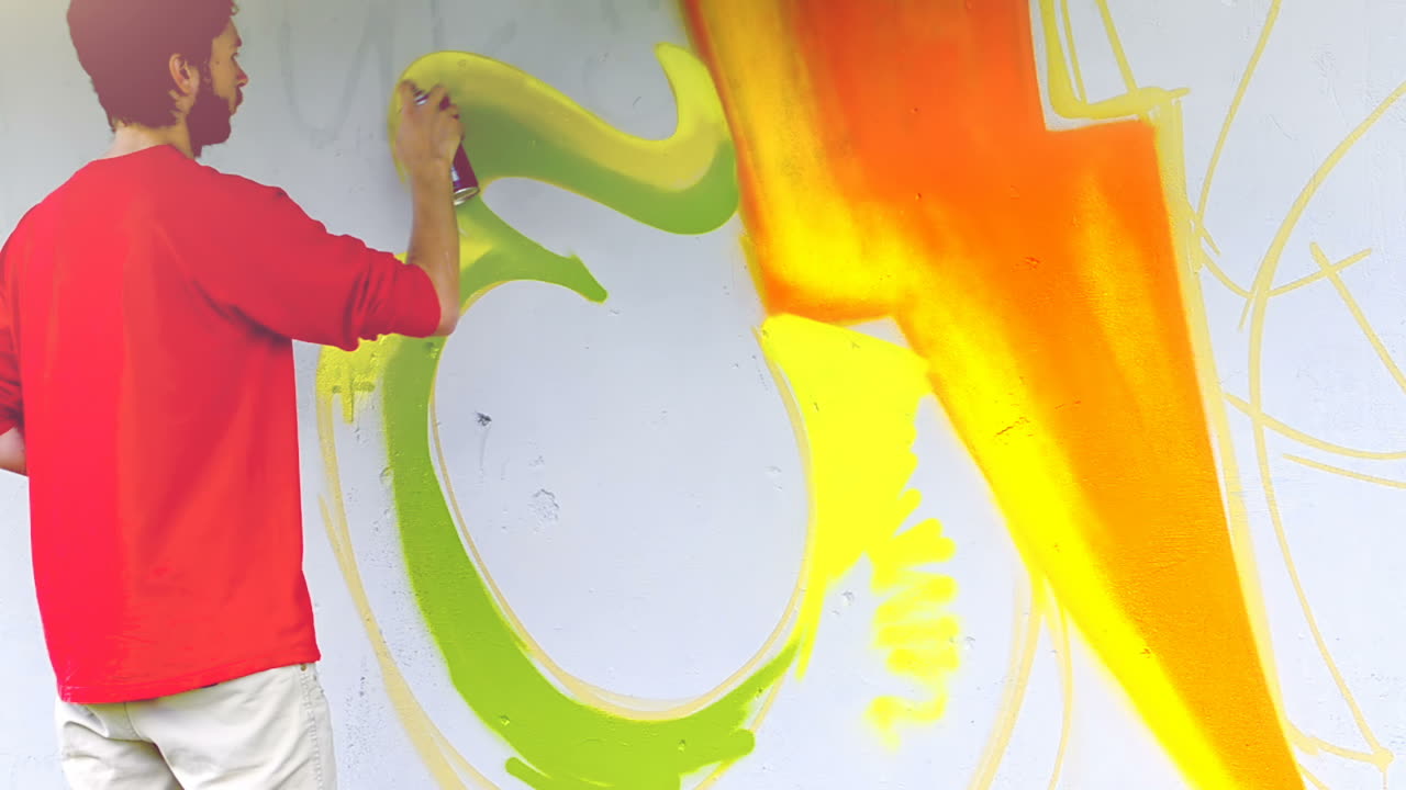L'artista disegna graffiti su una recinzione. Graffiti su una recinzione.