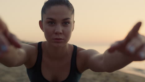 attractive face sporty girl practicing yoga on beach close up. woman exercising.