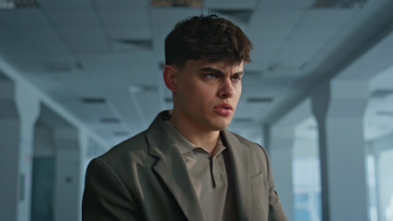 Disgruntled manager screaming smartphone feeling stress at office hall closeup