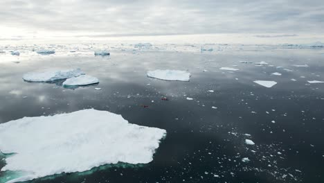 aerial scenic of polar landscape with many icebergs and dramatic sky