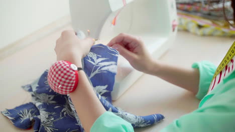 dressmaker using sewing machine.