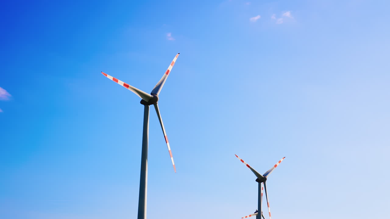 Wind turbines create solar energy. Tall wind turbines rotate against a clear blue sky, harnessing wind energy to produce clean electricity