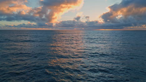 drone tranquil ocean waves under cloudy sky early morning. sea rippling sunrise