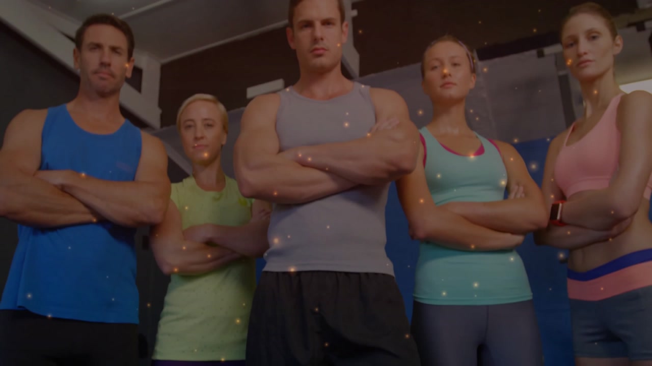 Zooming out revealing fitness trainers crossing arms with spark overlay and trainer speaking