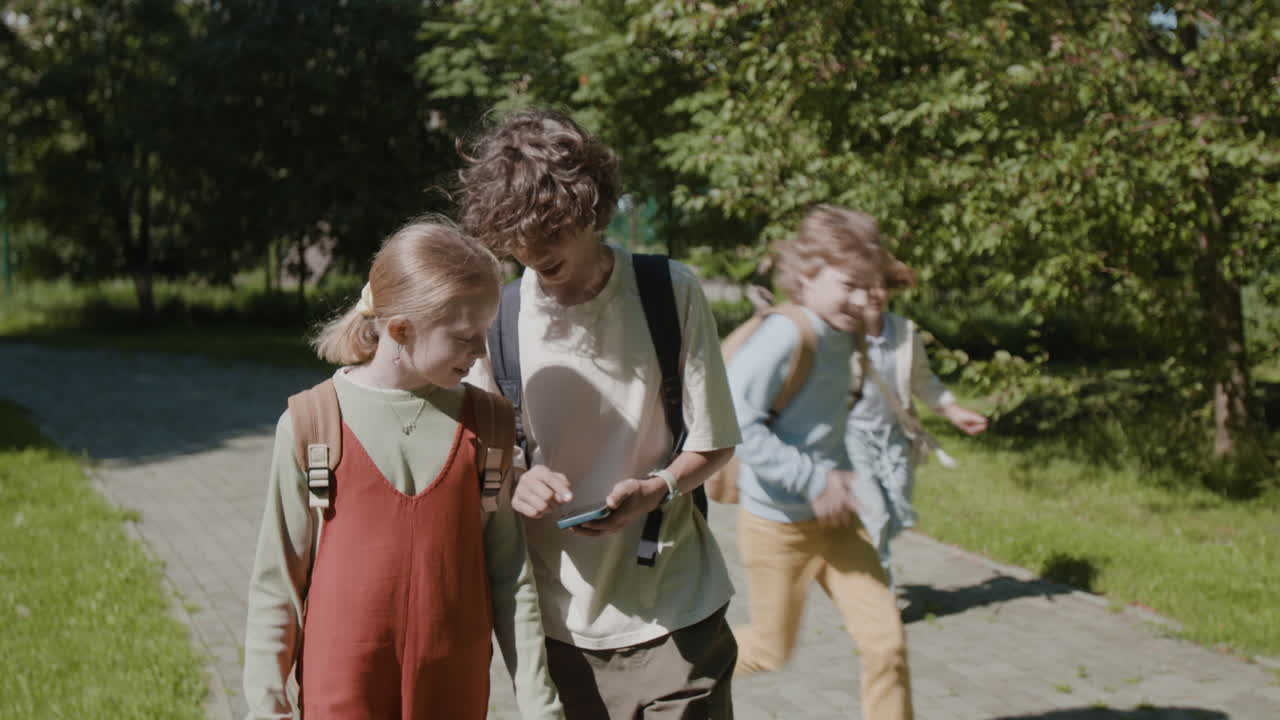 Children walking and playing outdoors in a park