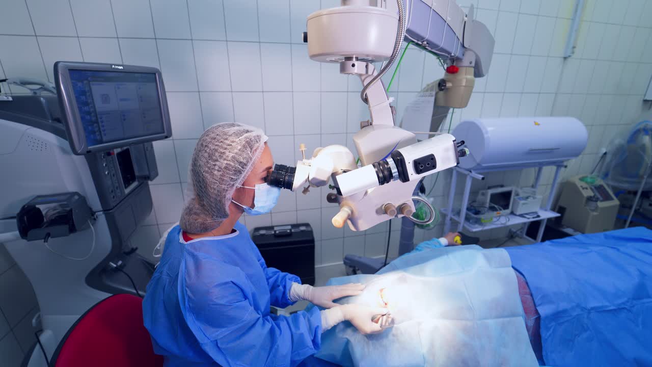 Ophthalmology laser microscope operation. Surgeon team in uniform in front of eye vision surgery operation room at medical clinic