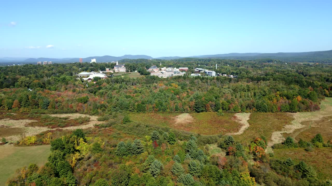 Aerial view of Amherst College amidst fall foliage and serene landscape