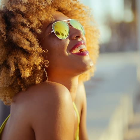 smiling girl with afro resting on promenade