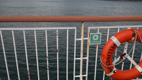 lifebuoy on a moving ship's side railing with the word 'wellington' written on it