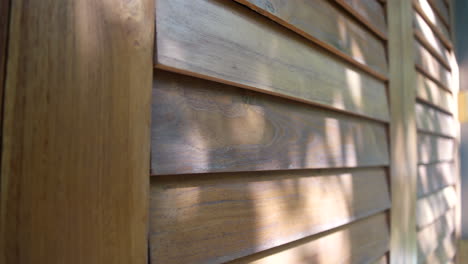 exterior of a wooden window frame with sunlight reflection on summertime