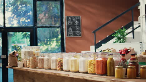 pasta and sauces in reusable glass jars on store shelves