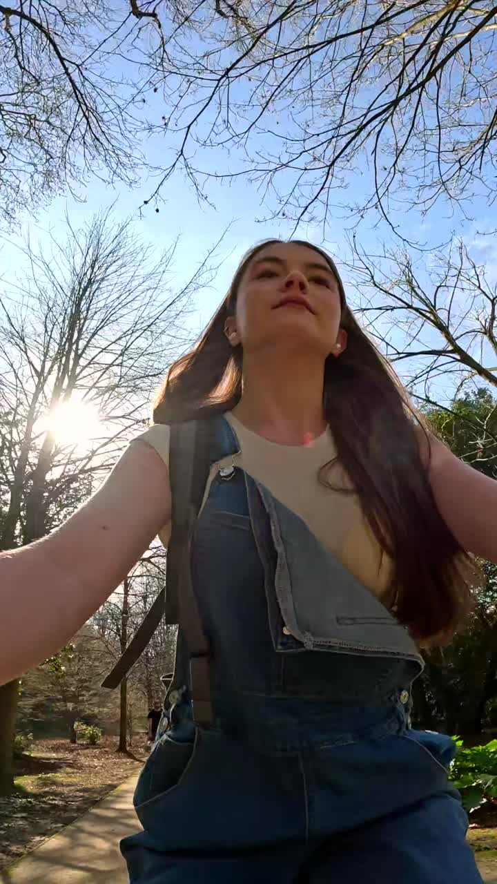 Woman in overalls under the sunlight