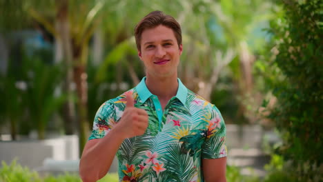 man giving thumbs up in tropical shirt