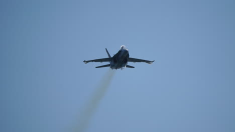 military jet aircraft flying in slow motion with visible vapor cone from shockwave caused by pressure difference