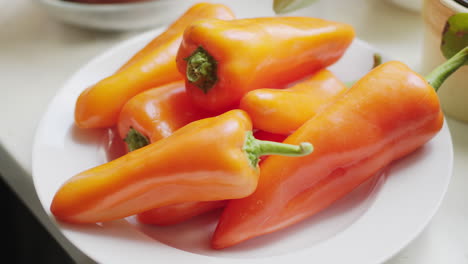 Orange-sweet-point-peppers-presented-on-a-white-plate