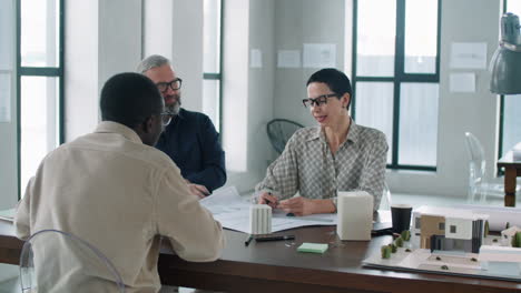 Multiethnic-Team-of-Colleagues-Discussing-Architectural-Project-in-Office