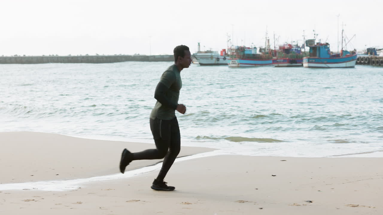 Running, fitness and man on beach for exercise
