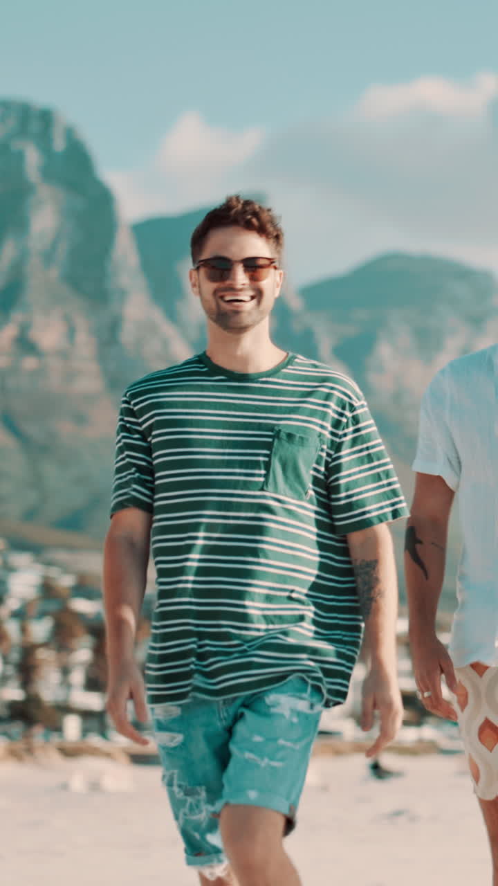 Two Happy Young Men Walking on a Sunny Beach