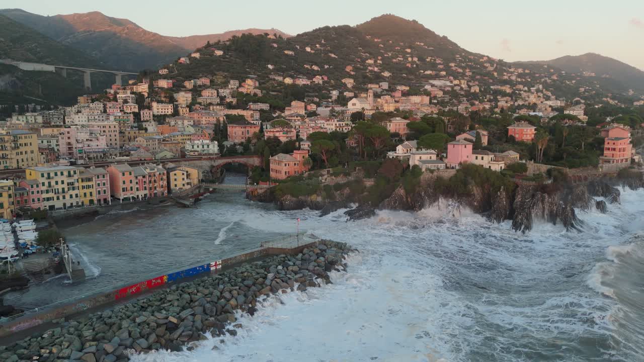 Massive waves crashing on shore of Genoa city harbor with pier breaker