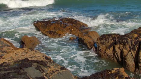 close-up of the irish sea as it violently crashes on rocks along the irish coast