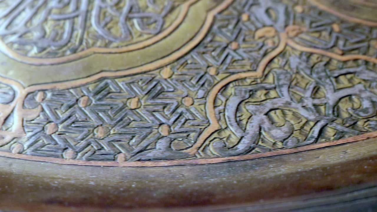 Background shot of a souvenir tray rotating with Arabic religious script
