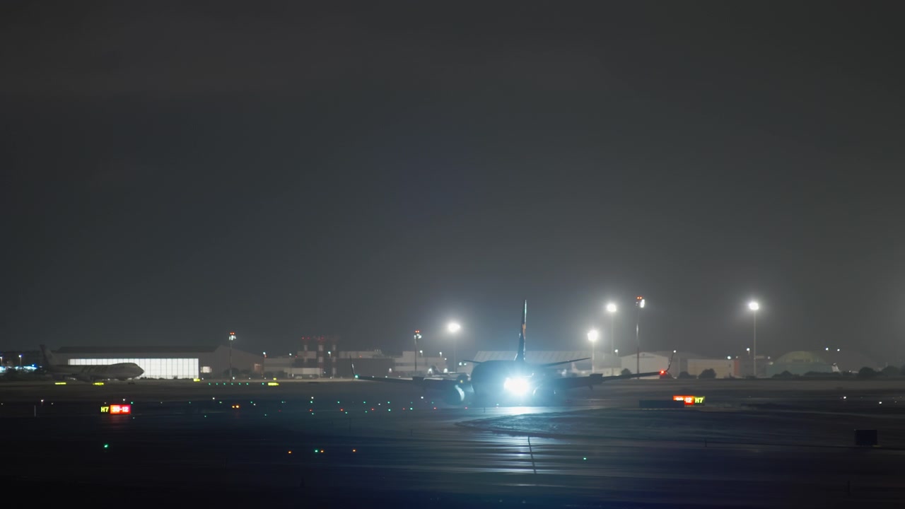 Aereo passeggeri in rullaggio in un aeroporto di notte