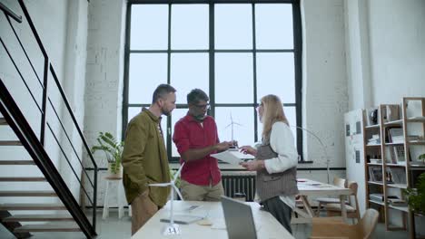 business team collaborating on wind energy project in modern office