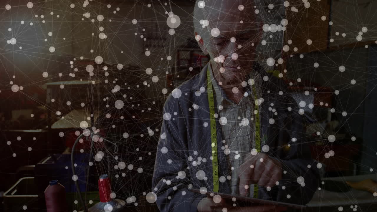 Using tablet with data processing animation, elderly tailor connecting to network