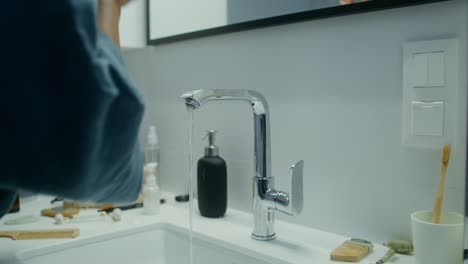 woman applying skincare in bathroom