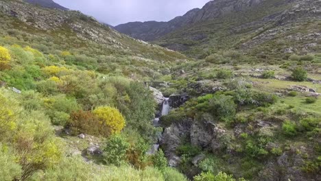 little stream with waterfall in a valley in palencia aerial shot