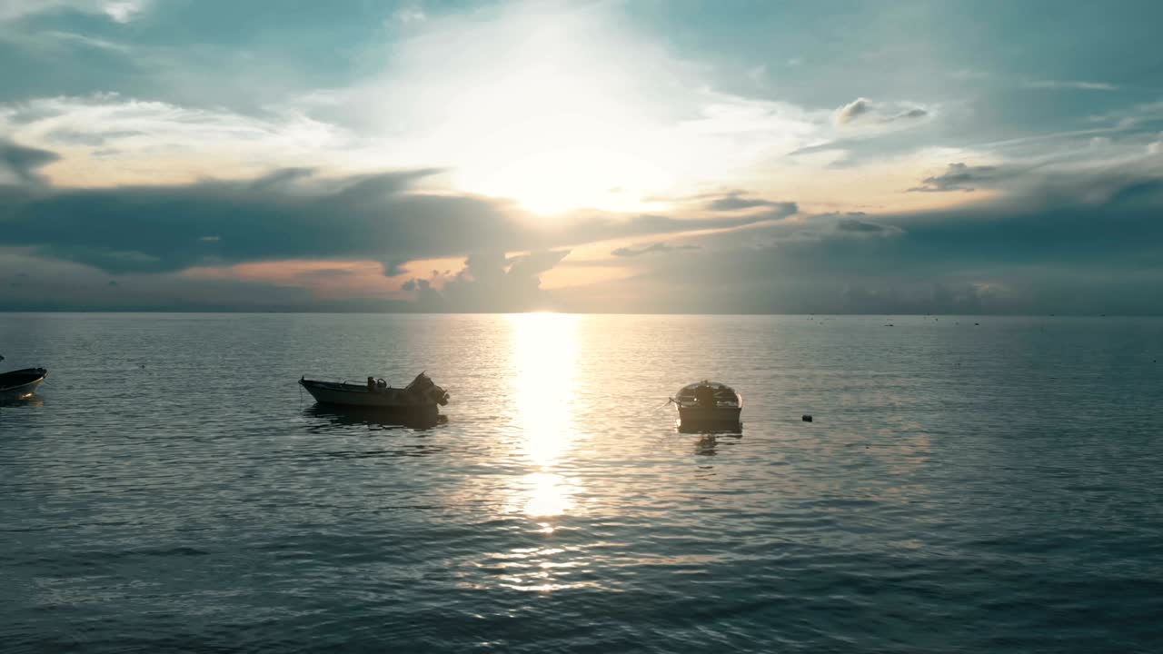 flying over boats toward sunset