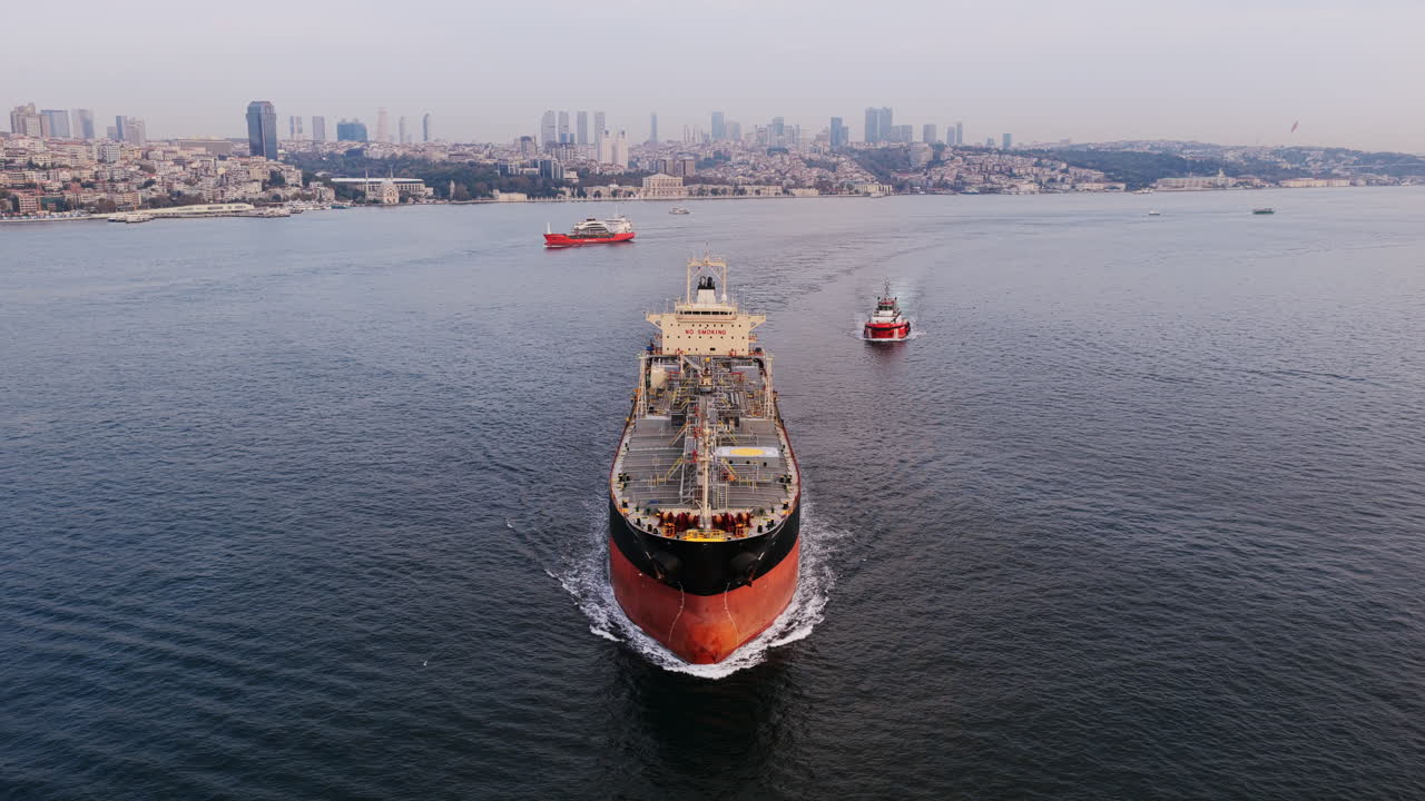 A powerful ship heads toward Istanbul’s skyline, framed by the hills and modern towers of the European side