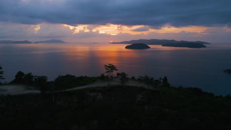 aerial drone view of hundred steps beach at sunset in palawan, philippines – cinematic horizontal shot with ocean, cliffs and golden light