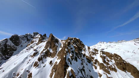 snowcapped mountain ridge and ski slopes at les marecottes ski resort, valais, switzerland with dents du midi mountains and frozen salanfe lake on the backdrop